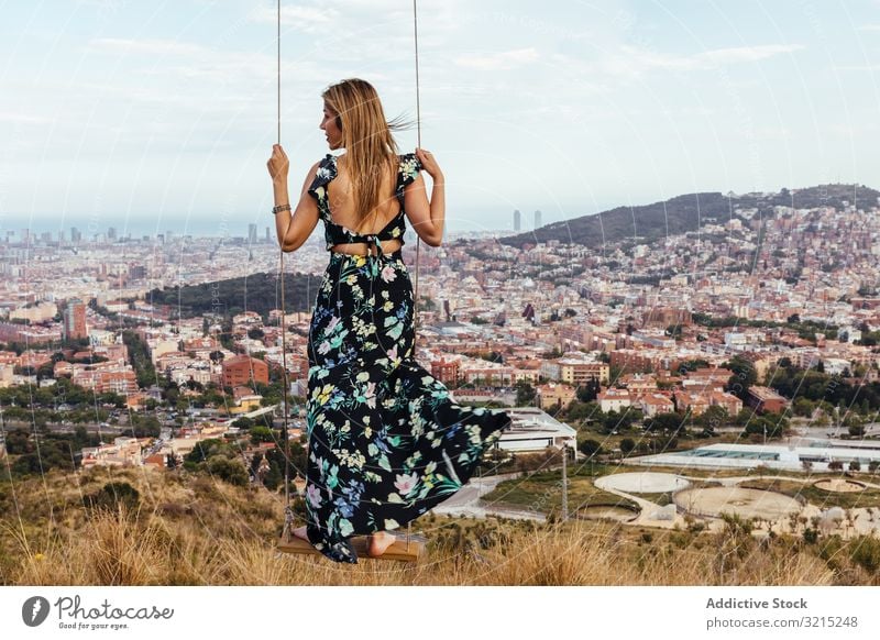 Girl from behind on a swing girl woman sky person female sitting dress nature city barcelona back young summer beautiful swinging outdoors happy play alone