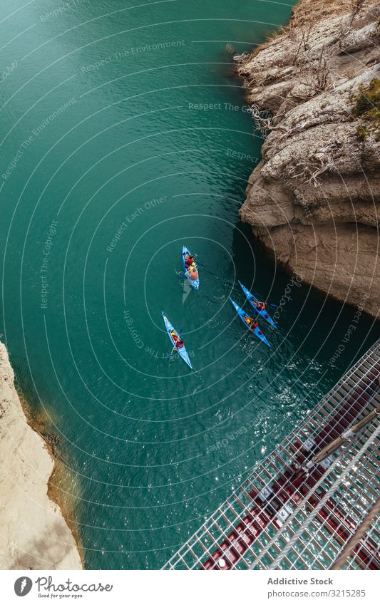 People crossing a river by kayak water people lifestyle sports kayaking travel landscape recreation activity boat summer rowing nature tourism blue boats sky