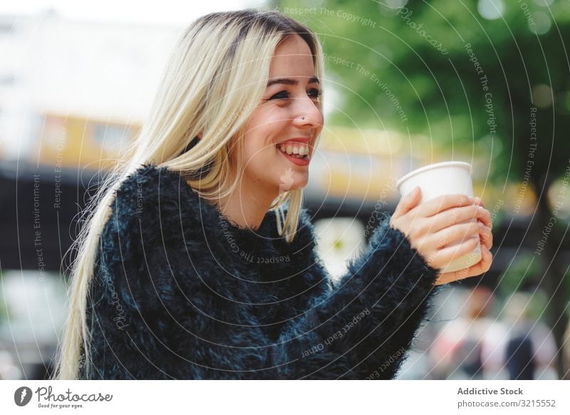 Beautiful woman drinking coffee in street cafe berlin blonde cheerful smile young beautiful fashion stylish elegant attractive casual hair model female trendy