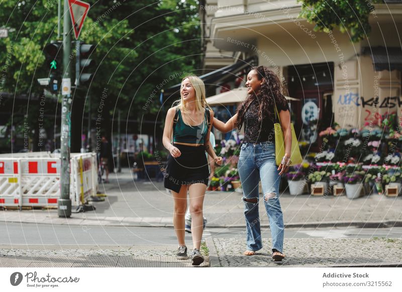 Cheerful friends walking on city street woman berlin summer together bonding smile cheerful young happy girlfriend beautiful sunny trendy casual stylish pretty