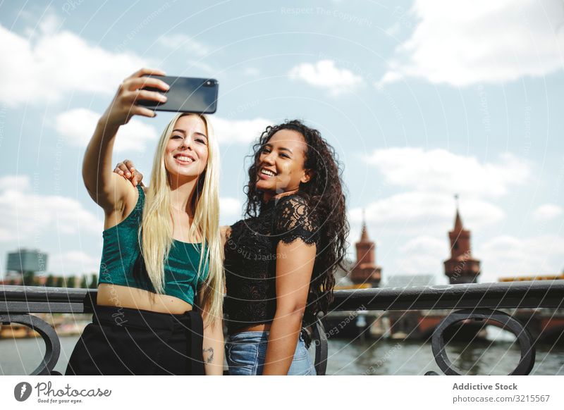 Friends taking selfie on sunny day woman friend berlin phone cheerful smile young multiethnic together multiracial beautiful female summer warm bonding