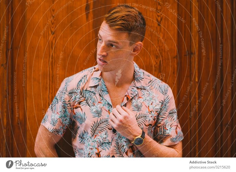 Man leaning on wooden door man handsome adult young hawaiian shirt male smart casual lifestyle leisure street red hair confidence stylish standing outdoors