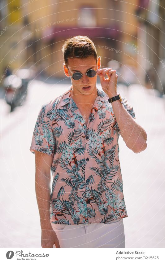 Handsome man standing on the street relaxing model style asphalt hawaiian shirt lifestyle adult handsome male trendy freckles casual urban red hair ground pose