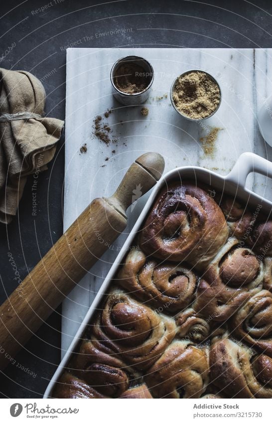 Baking dish with cinnamon rolls bun rolling pin baking tray cooking food dessert sweet delicious fresh homemade culinary prepared tasty yummy ingredient kitchen