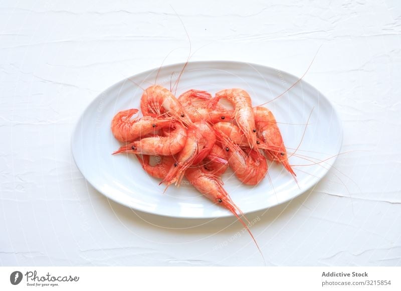 Shrimps served on white plate shrimp seafood prawn meal dinner cuisine fresh delicious gourmet appetizer dish prepared cooked boiled oval lunch tasty eat