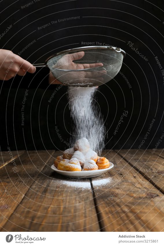 Person sprinkling icing sugar over on cookies sprinkle food biscuit pastry sieve homemade chef sweet delicious powder bakery decorating dessert cake snack fresh
