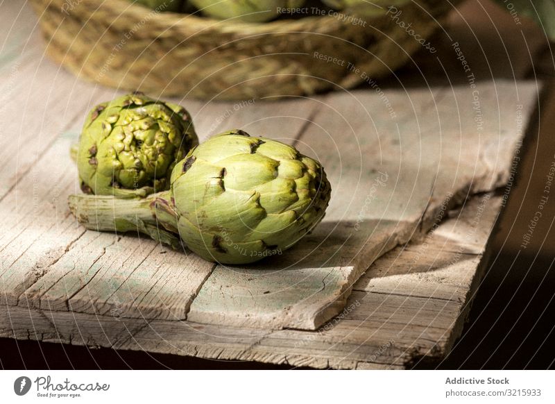 Green artichoke on wooden table green fresh vegetable food healthy raw vegetarian ingredient whole organic eat agriculture nutrition edible delicious ripe tasty
