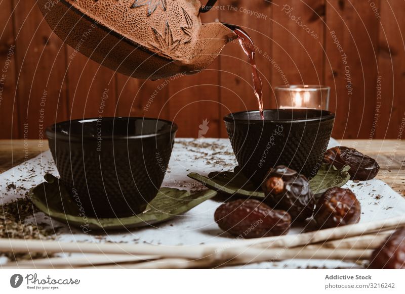 Aromatic tea dates and clay teapot on table leaves herbal drink green hot natural traditional beverage bowl oriental antioxidant gourmet ceremony ramadan teacup