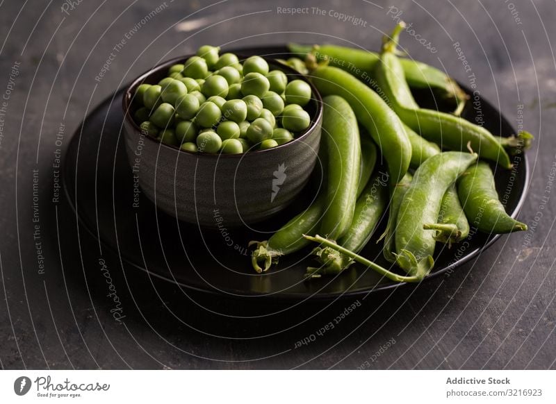 Fresh peas and pea pods on dark background bowl ecological food fresh green healthy legume natural organic raw seed vegetable vegetarian harvest nutrition sweet