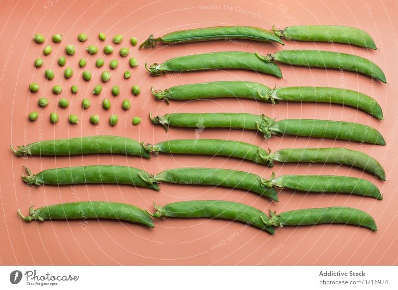 USA flag made with peas and pea pods flat lay food fresh green healthy legume natural old glory organic raw seed set stars and stripes vegetable cardboard