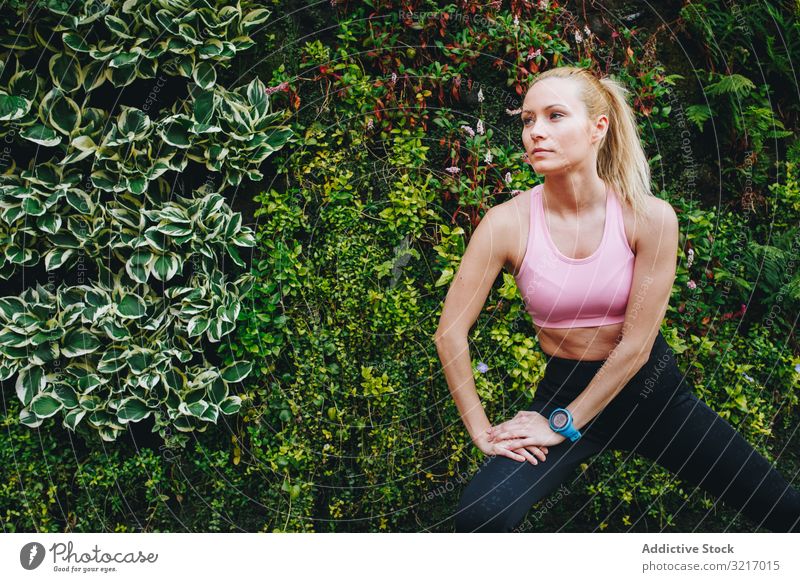 Woman doing some elongation exercises active athletic beautiful blonde body cardio caucasian fitness gym healthy jog lifestyle outdoors resting runner slim