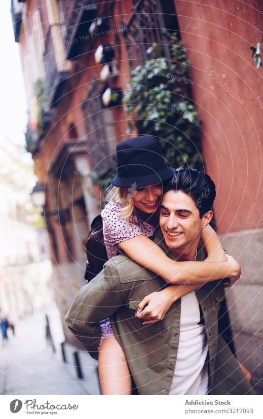 Happy couple having fun while walking in town happy young piggyback cheerful woman casual clothes dating enjoying girlfriend boyfriend love flirting lifestyle