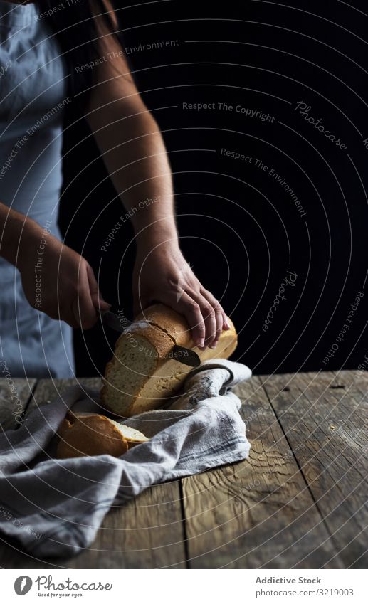 Crop woman cutting bread table rustic wooden old knife loaf fresh napkin food female healthy meal lunch dinner kitchen preparation piece slice lady lumber