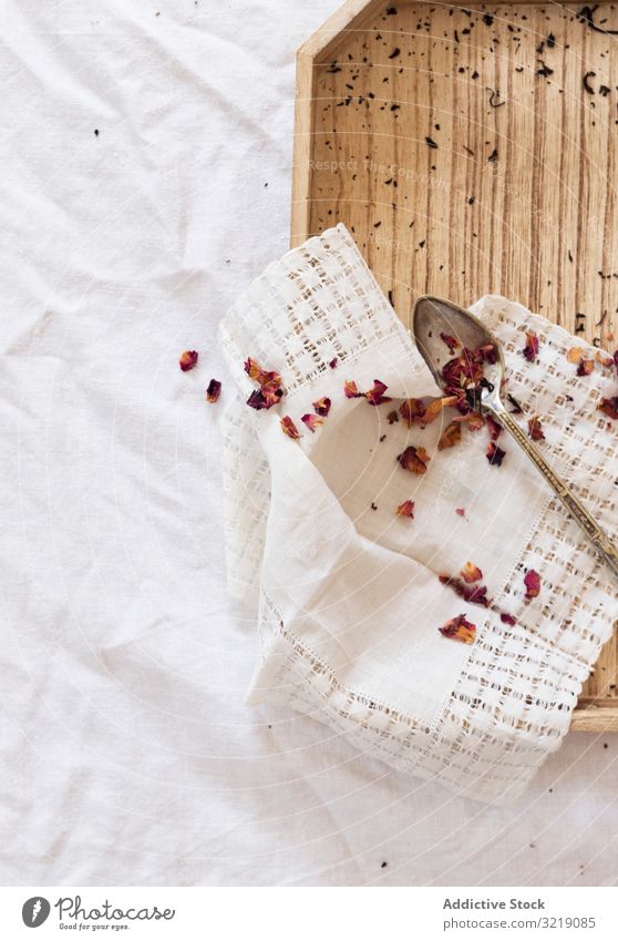 Dried tea and petals on tray leaf dried napkin fabric white aroma natural organic herb healthy fresh plant drink beverage ingredient traditional breakfast cloth
