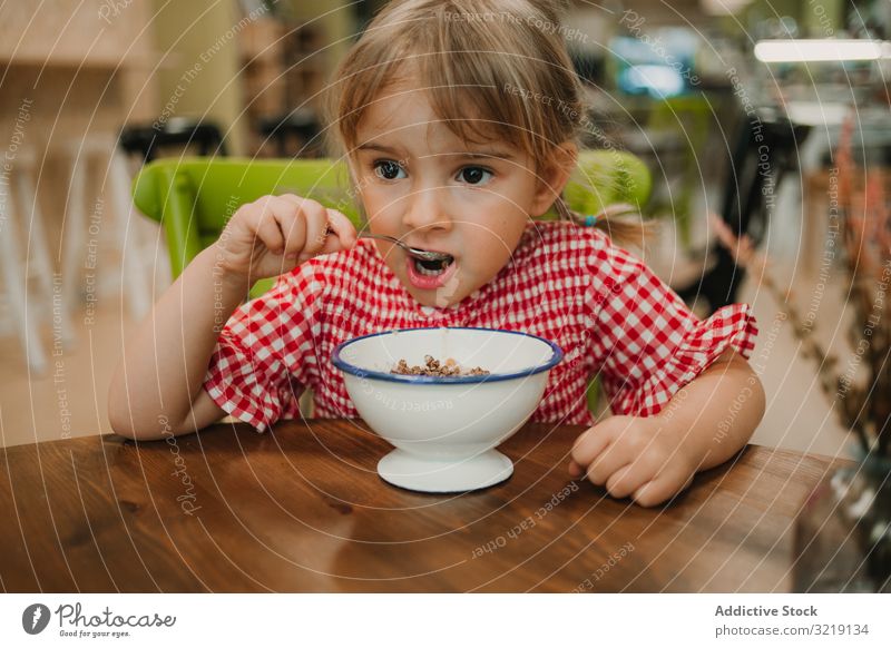 Girl eating with hand from white bowl girl gourmet homemade organic nutrition tasty breakfast refreshing raw adorable delicious yellow holiday innocence