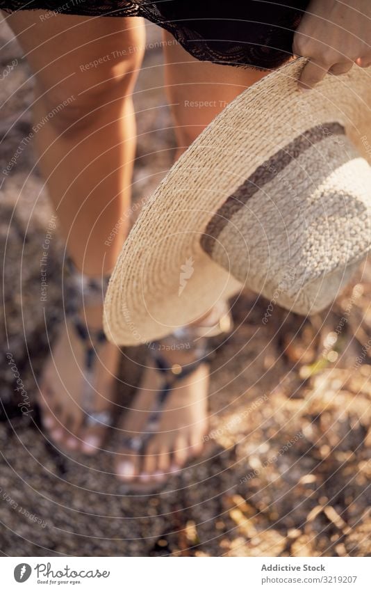 From above woman holding hat in hand summer accessory fashion stylish trendy relax travel vacation holiday straw rest nature standing beach boho tourism clothes