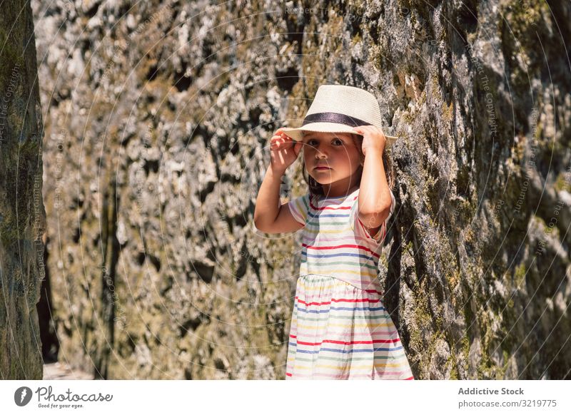 Girl in narrow stone walkway girl adventure happy walking sunlight wall travel tourist nature summer holiday child architecture building destination old