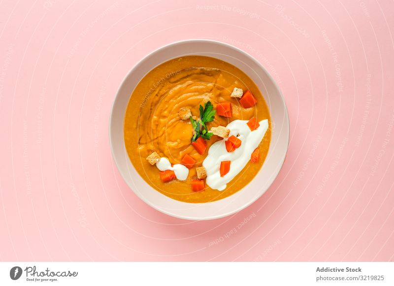 Orange vegetable cream with slices of carrots and herbs soup tasty veggie nutrition orange round meal food delicious vegetarian gourmet fresh aromatic