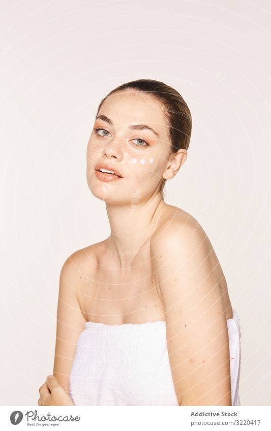 Pretty woman with cream on face care skin luxury cosmetic cosmetology graceful amiable pure pose female apply body model naked beautiful sensual healthy