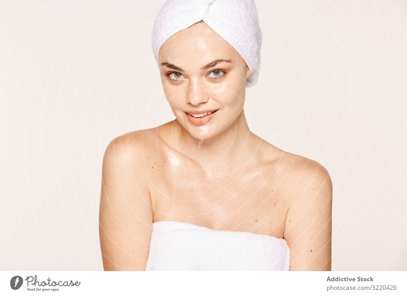 Attractive female with radiant body after cosmetic procedure woman skin face moisturize good-looking attractive pose towel care beauty cream skincare