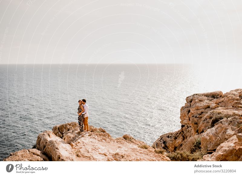 Couple embracing on rock Formentera balearic islands Spain couple cliff ocean sea summer harmony serene peaceful journey embrace excitement achievement nature
