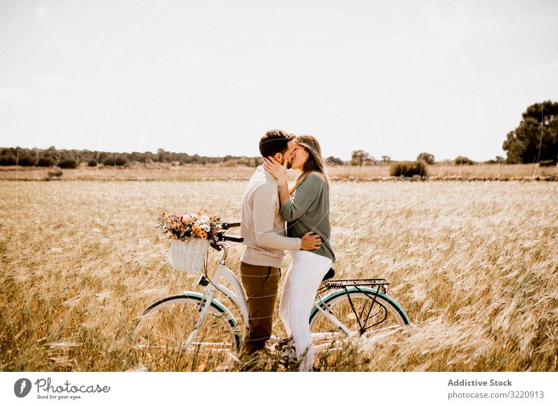 Sincere lovers posing by bicycle on rye field Formentera balearic islands Spain couple amorous sincere summer close vintage countryside affection vacation
