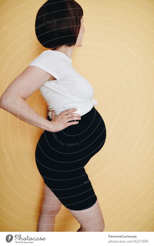 Urban young pregnant woman - neutral background Feminine Woman Adults 1 Human being 18 - 30 years Youth (Young adults) 30 - 45 years Happy Maternity wear