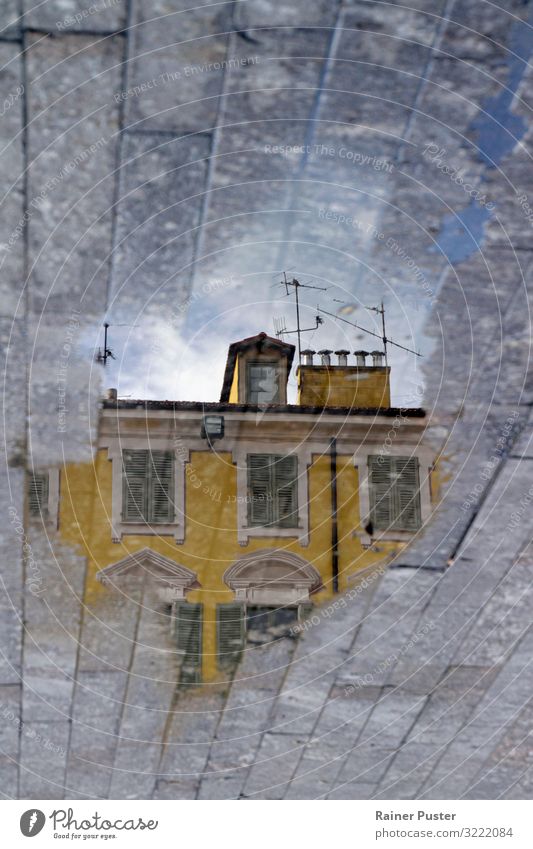 Mirror world: building reflected in a puddle Rain Puddle Nice Downtown Exceptional Wet Blue Yellow Gray Optimism Expectation Idyll Reflection Colour photo