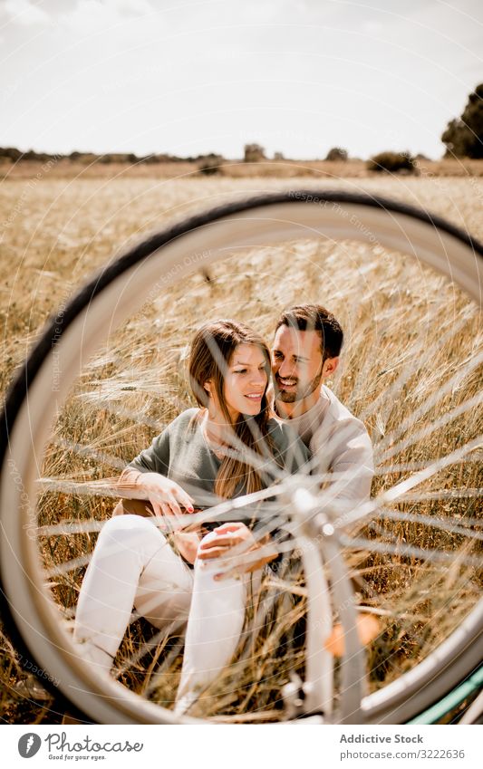Loving couple resting on rye field relax love tender harmony summertime wheat recreate dream bicycle laugh nature wheel romance happy leisure together