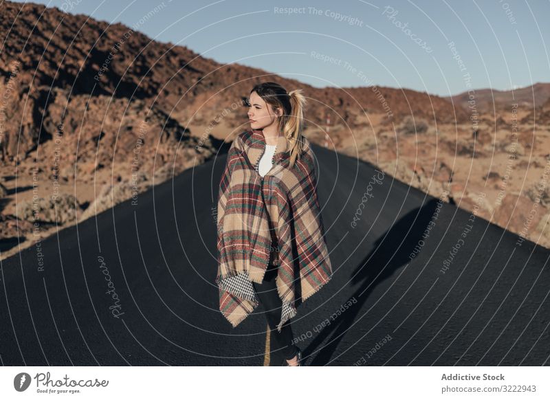 Traveler wearing blanket in sun during road trip woman mountains tenerife dream traveler bask young plaid female attractive cold wrapped cozy stand hill spain
