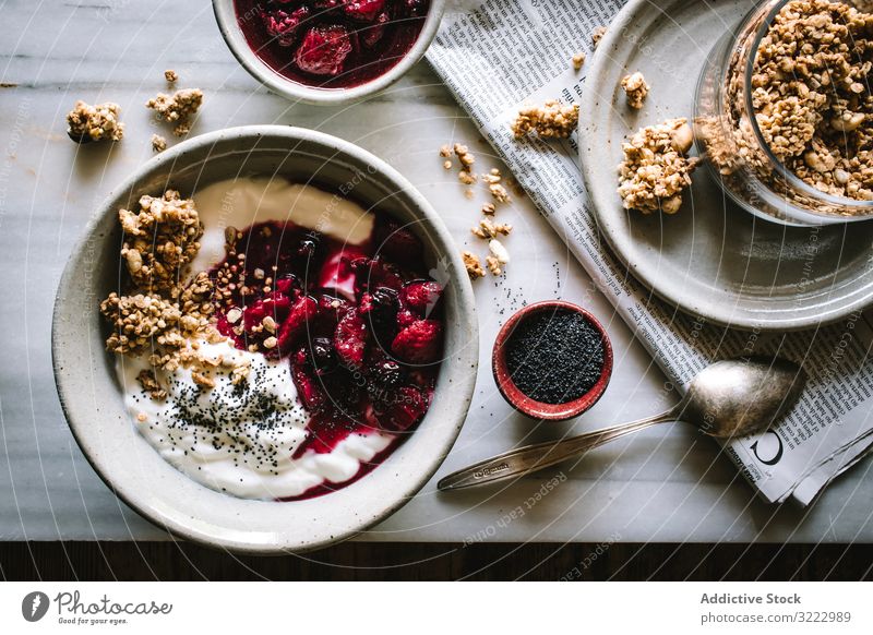 Delicious breakfast bowl with quinoa, rice and groats near tea cup and newspaper food morning berries chia seed diet healthy delicious nutrition crunchy crispy