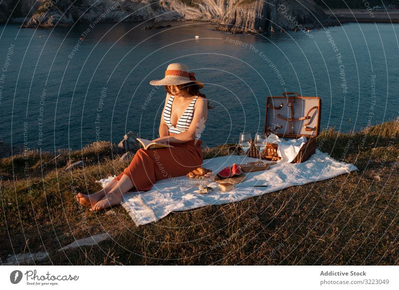 Woman reading on mat for picnic on seashore woman book seaside beach summer leisure sky relax glass drink vacation summertime vintage fashion refreshing