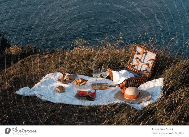 Picnic mat with romantically set near sea and mountains seaside picnic beach summer leisure sky relax glass drink vacation summertime vintage fashion refreshing