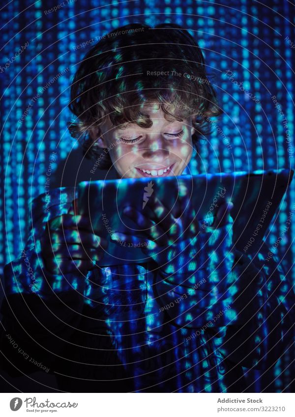 Hacker boy using tablet hacker code database little programmer virus digital password software kid child device gadget browsing scam website symbol glow
