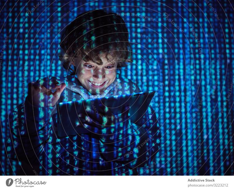 Hacker boy using tablet hacker code database little programmer virus digital password software kid child device gadget browsing scam website symbol glow