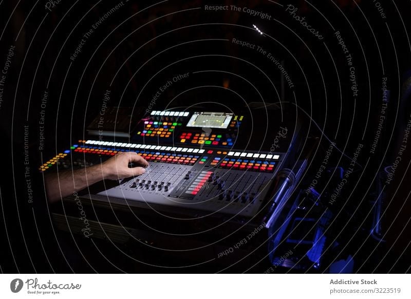 Sound mixer during a night concert man switch buttons volume digital electronic panel equalizer media board technology audio professional control equipment