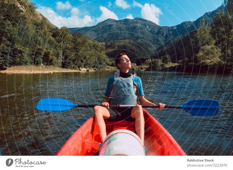 Young female kayaking on nature background woman paddle sport sella river spain adventure activity water tourism canoe lifestyle travel concentrated serious