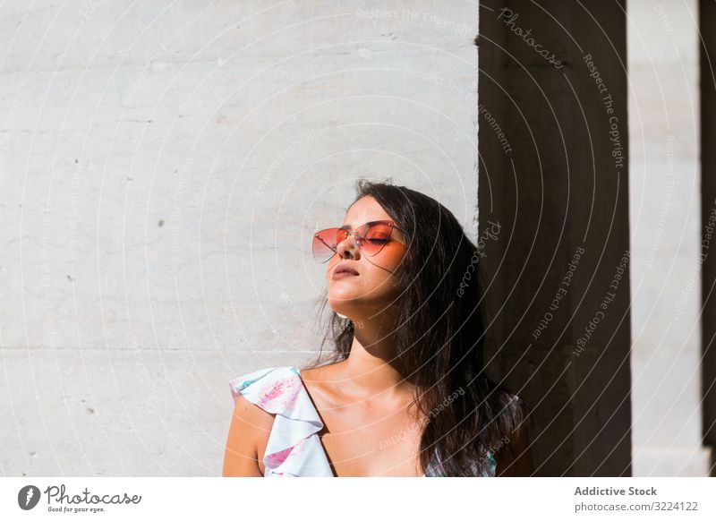 Dreamy stylish woman in sunglasses standing on city street dreamy trendy beautiful building portugal accessory lisbon pattern young adult exotic pensive