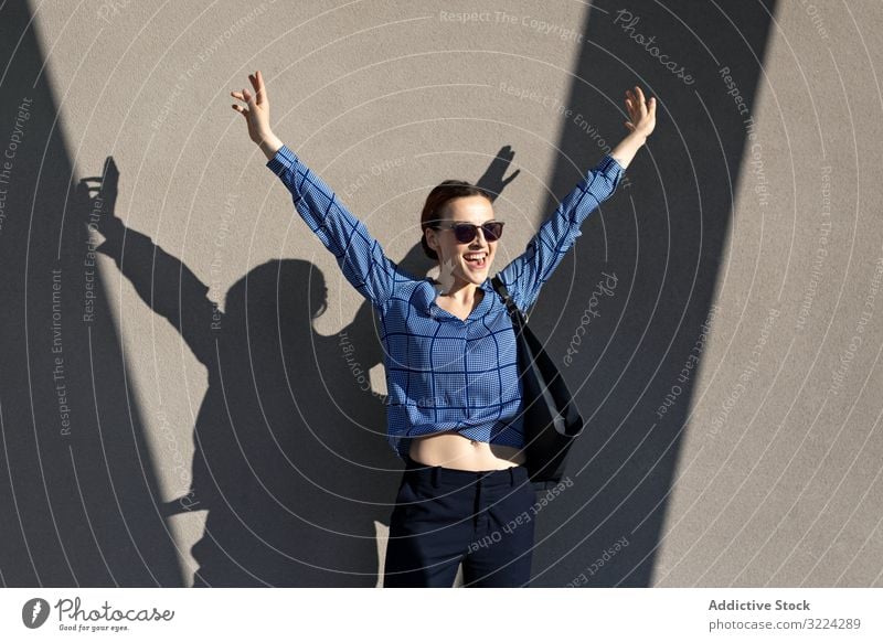 Excited businesswoman jumping success celebration excited raised arms achievement triumph female elegant trousers jacket cloudless blue lady victory win freedom