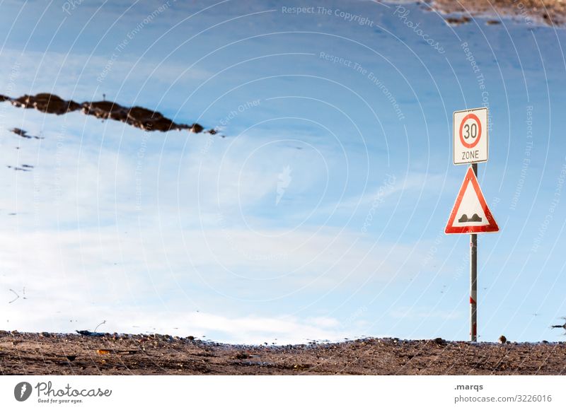 Zone 30 Water Puddle reflection Sky Signs and labeling Road sign traffic-calmed zone Hill Signage disorientation Transport 30 mph zone