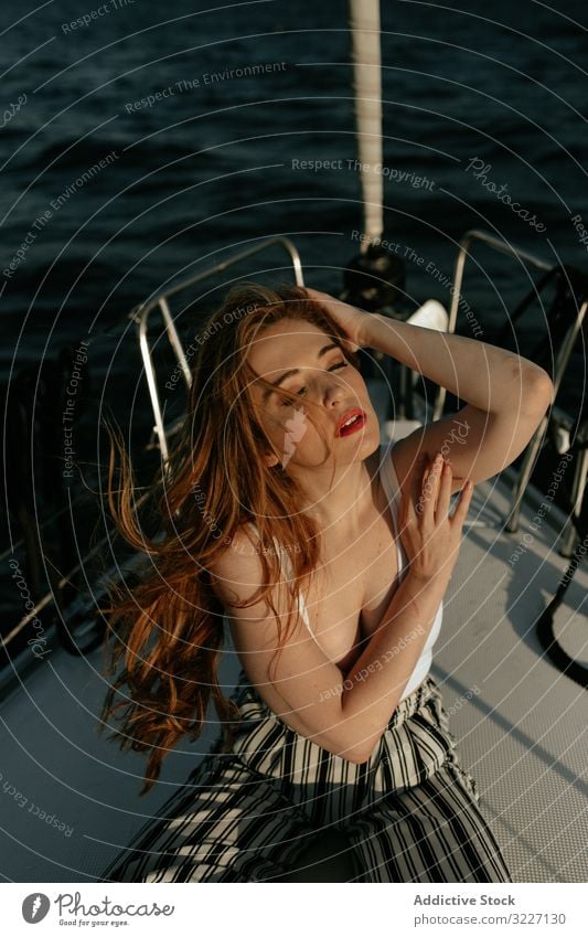 Pleased beautiful woman traveling at sea ship rest appealing yacht pleased relax redhead peaceful trip boat voyage ocean pretty calm attractive tranquil holiday