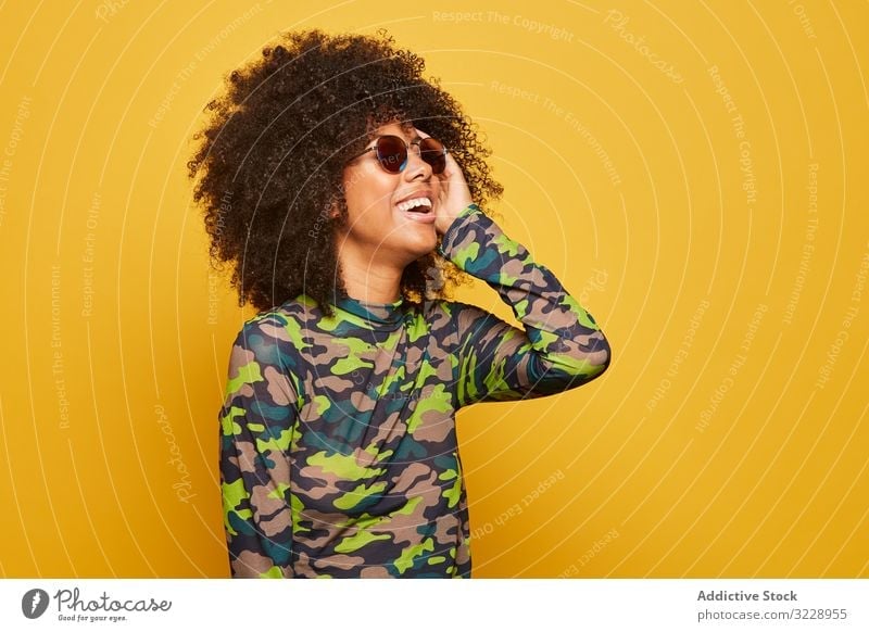 Trendy ethnic lady in sunglasses on bright backdrop woman colorful cool afro trendy vibrant happy vivid outfit modern hipster millennial attractive black