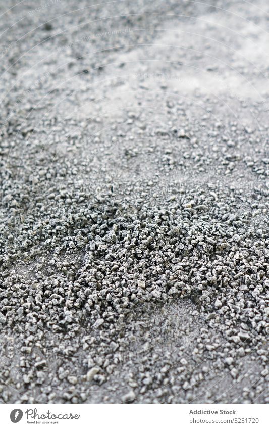 Pile of frosted pebble on ground pile texture small frozen rock grey icy snow natural abstract cobble dark boulder gravel material heap winter background
