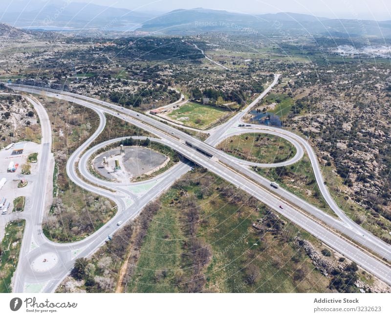 Urban road junction in suburb area countryside urban aerial drone view modern traffic car remote rural valley summer intersection landscape nature lane