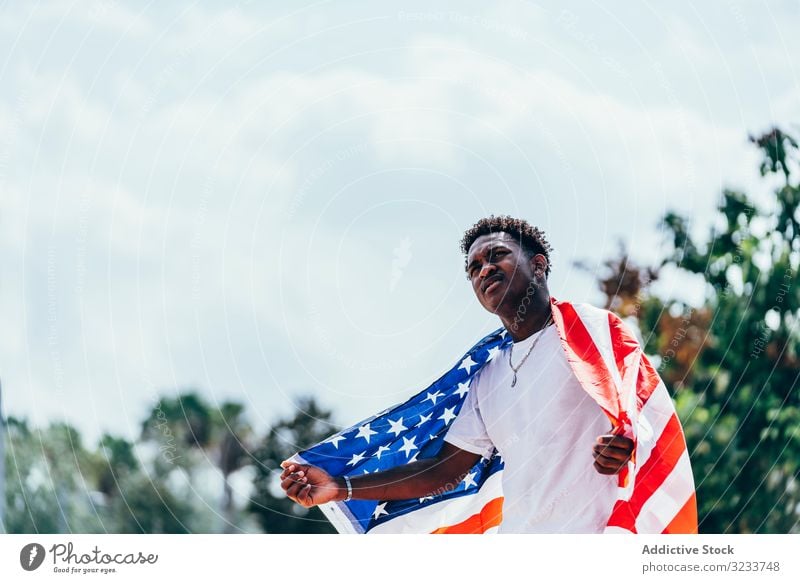 Black man wrapping in American Flag outside american flag wrapped black african american national independence active 4th of july banner celebrating freedom