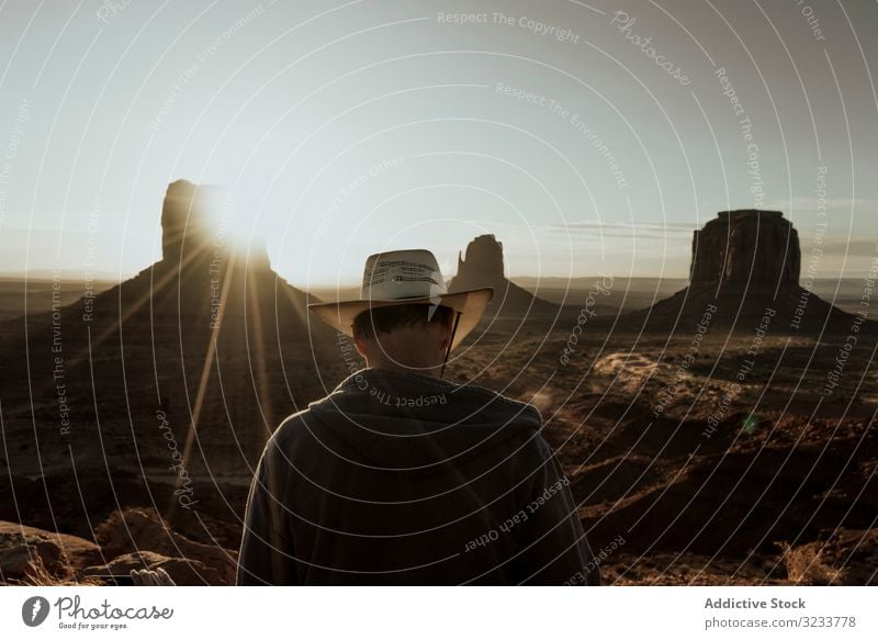 Man in hat looking at amazing structures in desert tourist travel nature landscape sunset old adventure ancient tourism sky beautiful ruins vacation natural
