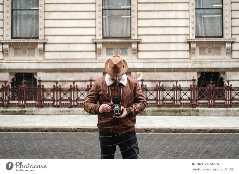 Male tourist walking near old building photo camera street retro photographer road man london england stand male adult city exterior great britain vintage