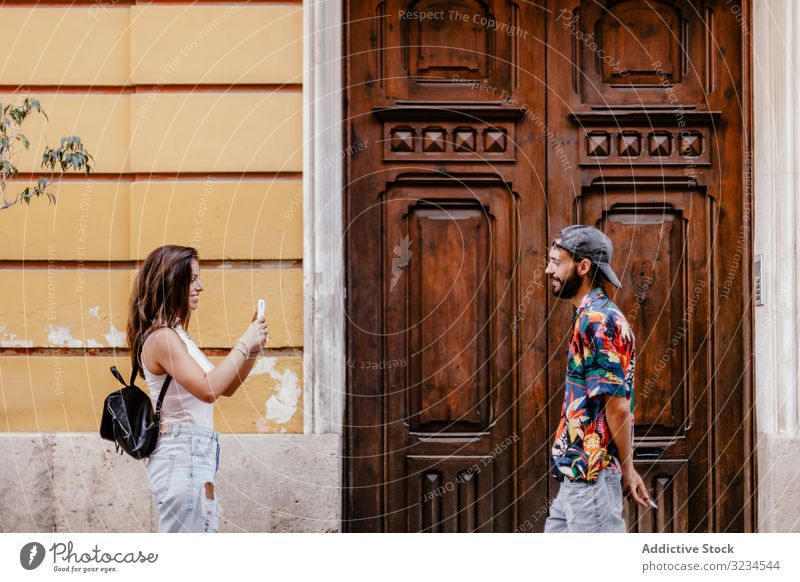 Female taking photo of bearded man couple street smartphone photography colorful together travel ethnic shirt lifestyle hipster touch screen city urban picture