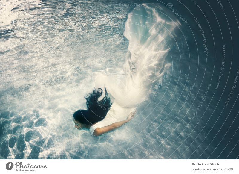 Woman in wedding dress floating underwater woman bride white brunette long hair depth enjoy female body pool swimming young romantic happy submerged beautiful