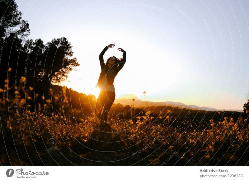 Woman walking on meadow and enjoying freedom woman nature sunset field harmony trees forest young casual female relaxed beautiful summer happiness wellness